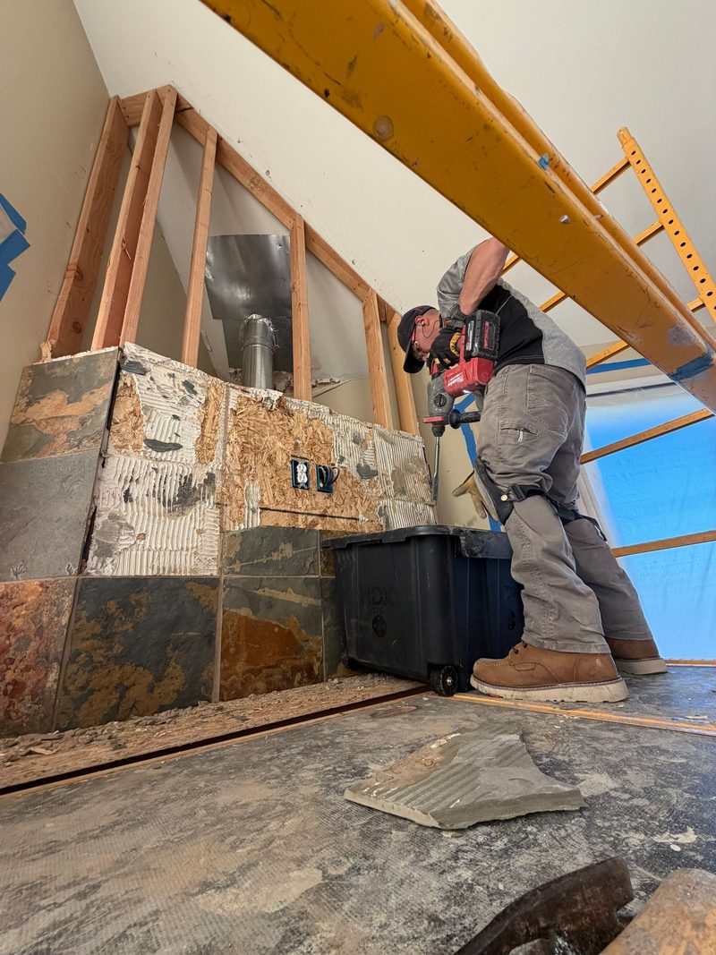 A Su Casa Handyman craftsman tiling a fireplace surround