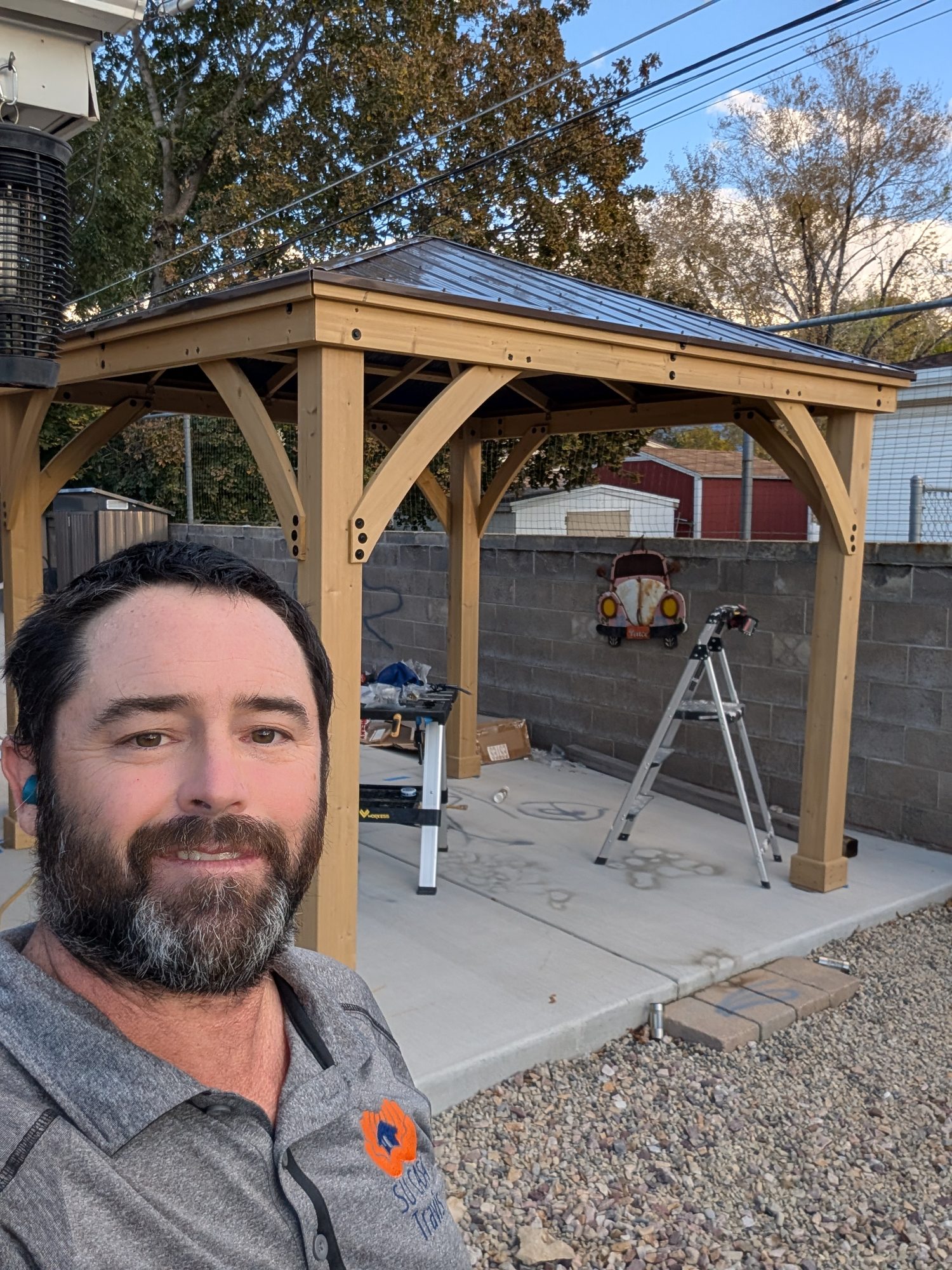 Travis of Su Casa Handyman in front of a finished cedar gazebo