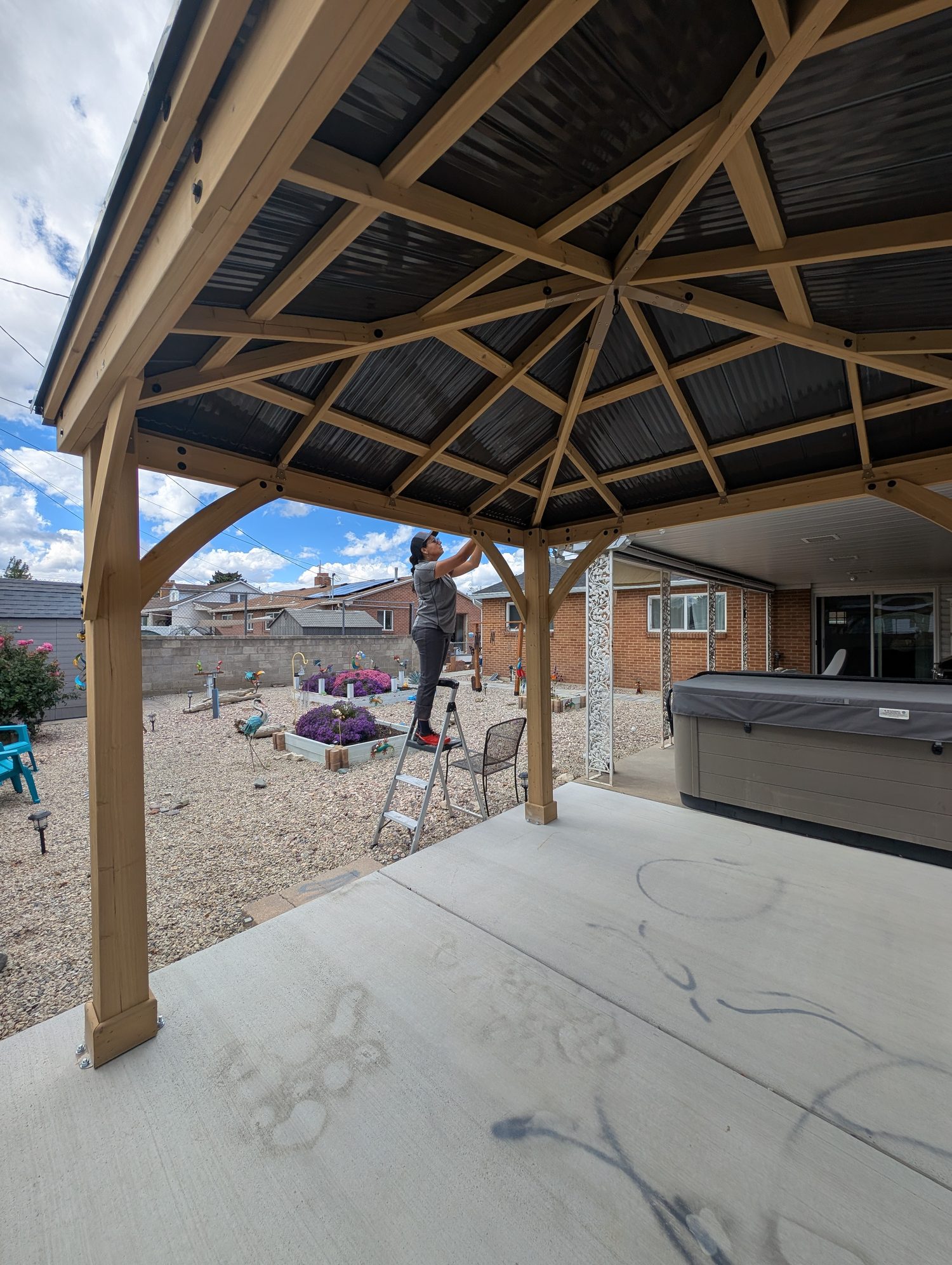 A Su Casa craftsman building a cedar gazebo on-site in a Salt Lake Valley backyard